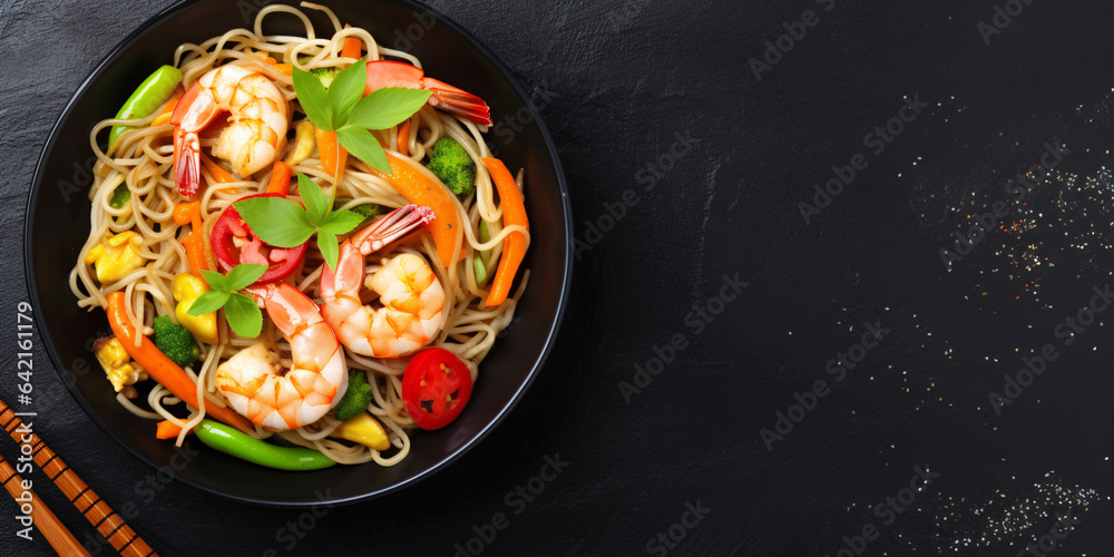 Overhead Perspective of Shrimp and Vegetable Stir-Fry Presented on a Black Slate Background.