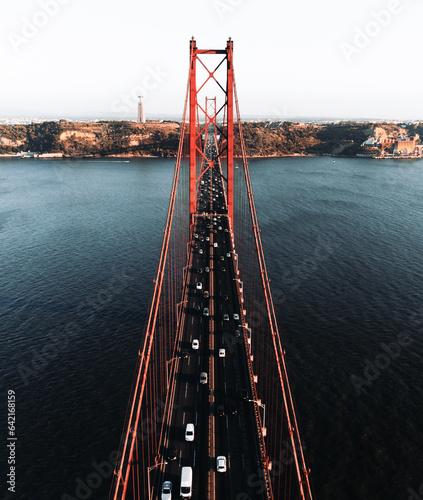 Aerial vertical photo of the 25 April bridge (Ponte 25 de Abril) located in Lisbon, Portugal, crossing the Targus river - taken by drone. photo