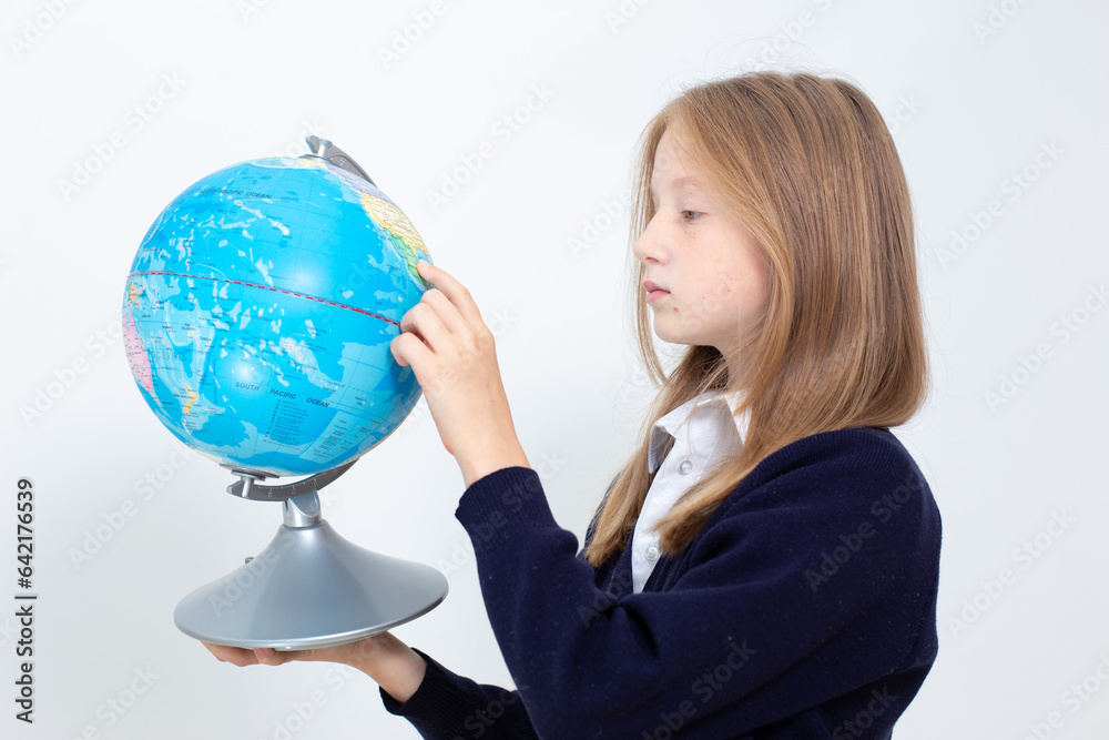 Schoolgirl holding globe. Back to school concept. High quality photo Schoolgirl holding globe. Back to school concept. High quality photo