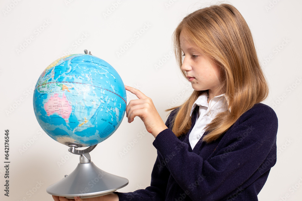 Schoolgirl holding globe. Back to school concept. High quality photo Schoolgirl holding globe. Back to school concept. High quality photo