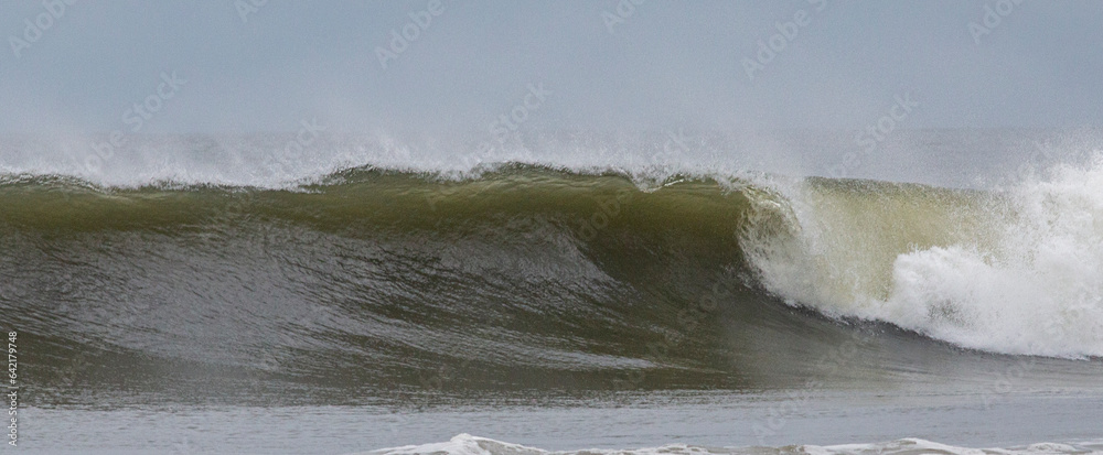 Pamorama of a arge wave off the coast of Gilgo Beach