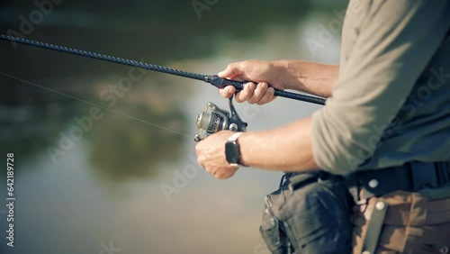 Fisherman catching fish perch on river	 photo