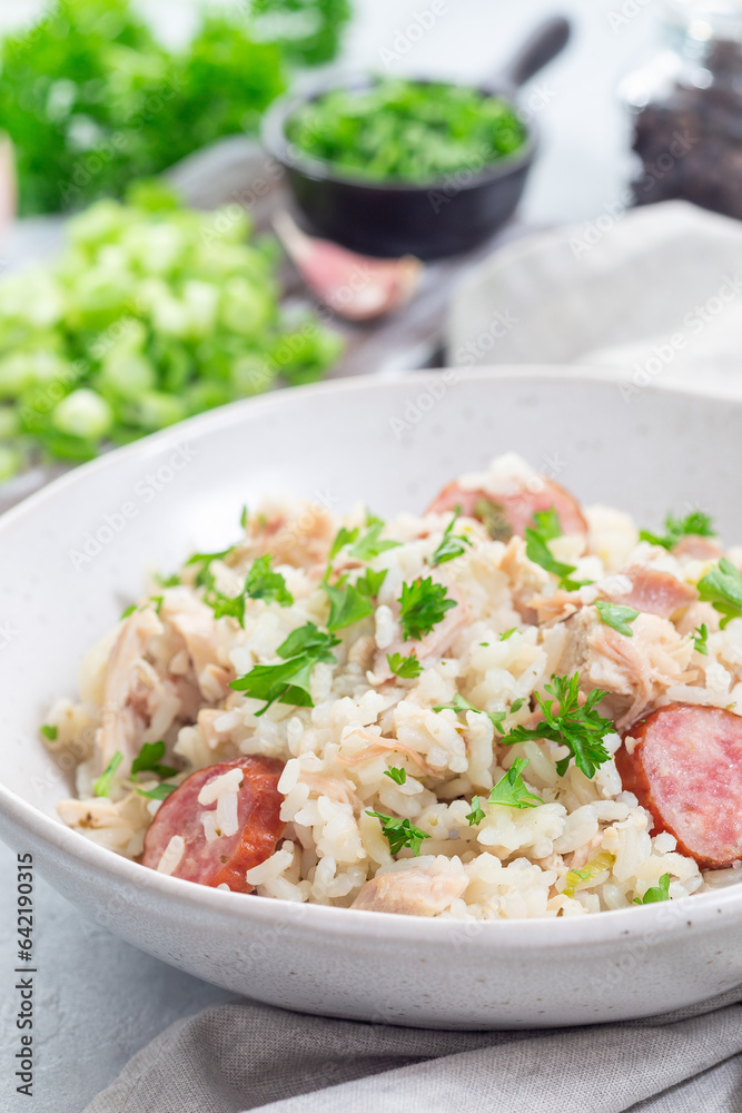 Chicken bog dish with smocked sausages, traditional South Carolina recipe, in bowl, vertical Chicken bog dish with smocked sausages, traditional South Carolina recipe, in bowl, vertical