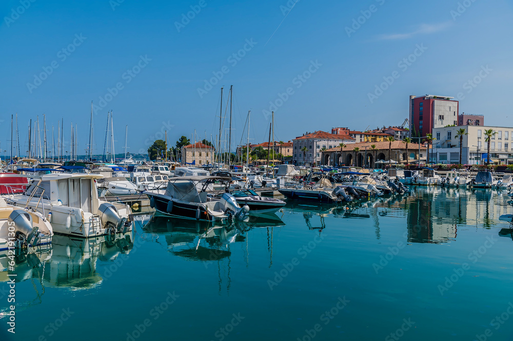 A view across boats moored in the harbour in Koper, Slovenia in summertime