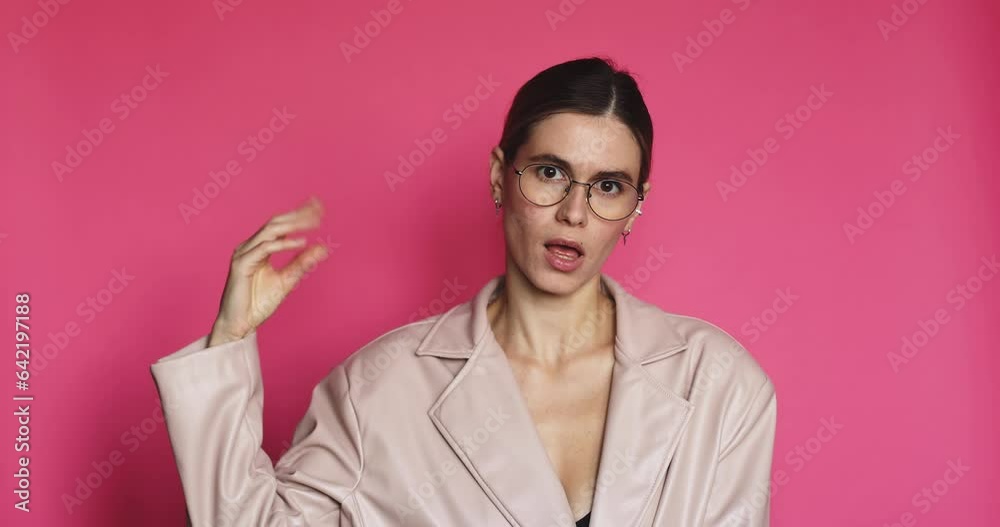 Pretty woman showing bla-bla-bla gesture with hand isolated on pink background. Empty promises, blah concept. Too much talking. Irritated and tired woman showing talking hands gesture, say blah blah Pretty woman showing bla-bla-bla gesture with hand isolated on pink background. Empty promises, blah concept. Too much talking. Irritated and tired woman showing talking hands gesture, say blah blah