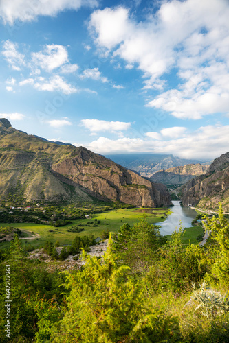 Beautiful landscape with mountains, valley and a river on a sunny summer day with clouds. Dagestan