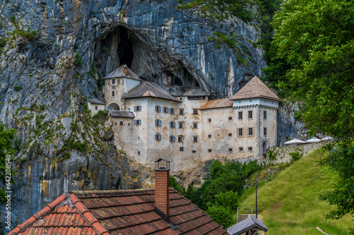 A close up view of the medieval castle built into the cliff face at Predjama, Slovenia in summertime photo