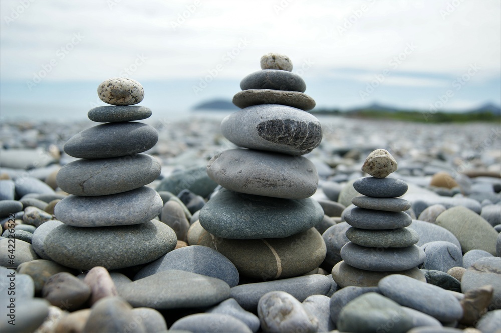 Towers made of pebbles. Three Zen towers on a stony beach.