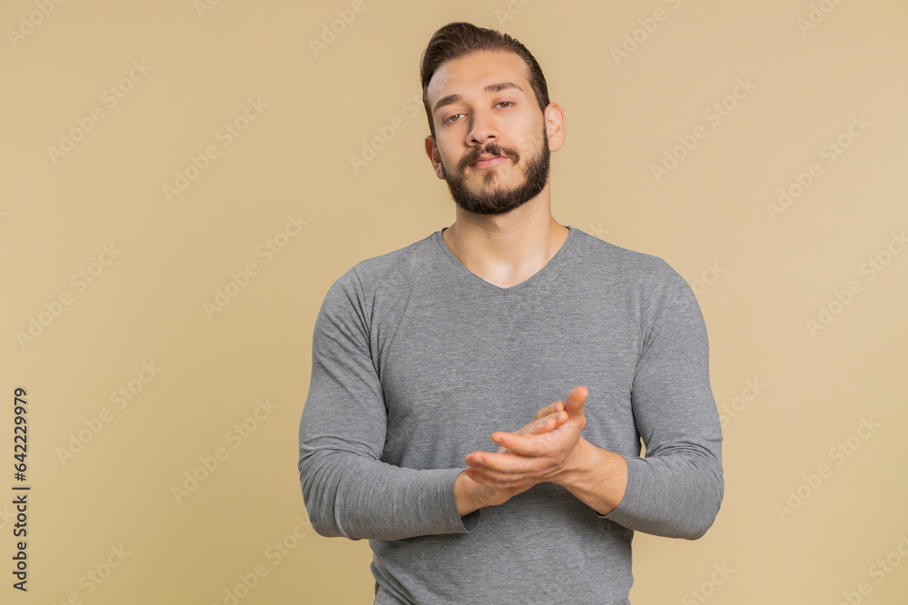 Well done good job. Lebanese young man showing thumbs up and nodding in approval, claps hands, successful nice work, satisfaction, celebrate. Middle eastern guy isolated on beige studio background Well done good job. Lebanese young man showing thumbs up and nodding in approval, claps hands, successful nice work, satisfaction, celebrate. Middle eastern guy isolated on beige studio background