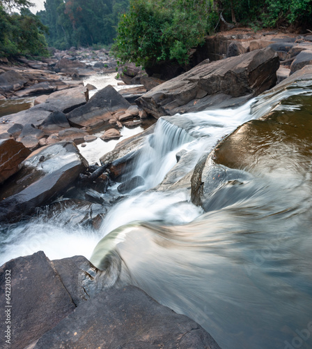 Waterfall cascades,over jagged rocks and boulders at Maak Ngaew falls,near Pakse,Southern Laos. photo