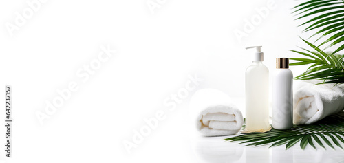 Set of Aroma spa product containers. Spa still life with cosmetic products and palm leaf on white background. Tubes without label.
