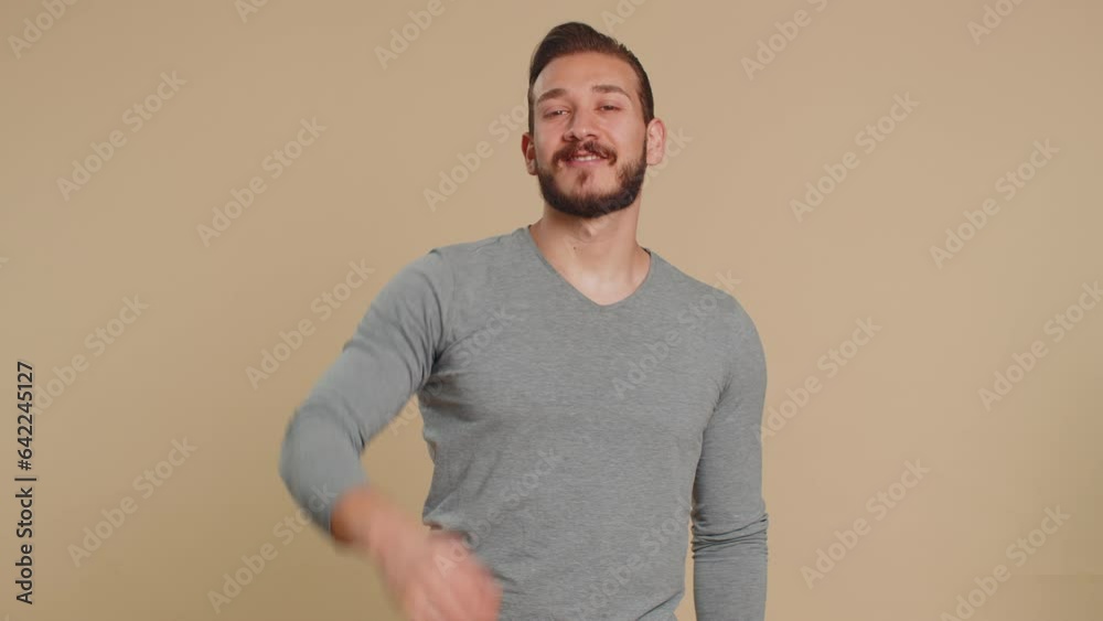 Ok. Joyful happy lebanese man in long sleeve looking approvingly at camera showing approve feedback gesture like sign positive something good. Handsome guy on beige background. People sincere emotion Ok. Joyful happy lebanese man in long sleeve looking approvingly at camera showing approve feedback gesture like sign positive something good. Handsome guy on beige background. People sincere emotion