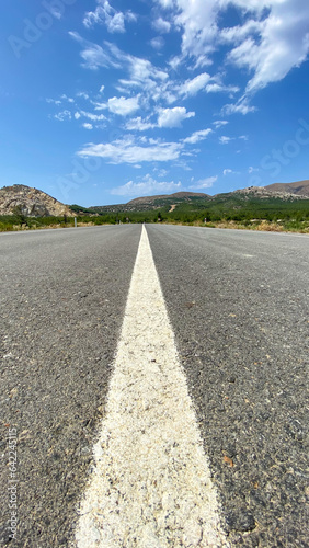 Straight asphalt road and natural landscape