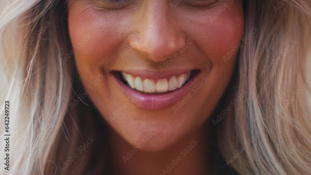 Close up shot of mature woman's smiling mouth as she looks at camera - shot in slow motion Close up shot of mature woman's smiling mouth as she looks at camera - shot in slow motion