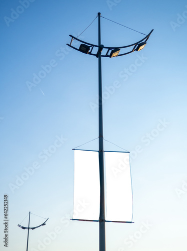 Advertising on a lamppost. Mocap against the sky. Place for advertising on a pole. Product promotion