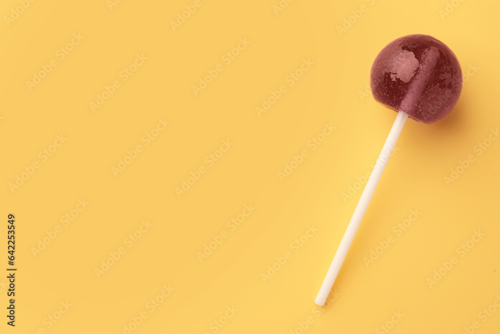 Tasty lollipop on yellow background, top view. Space for text Tasty lollipop on yellow background, top view. Space for text