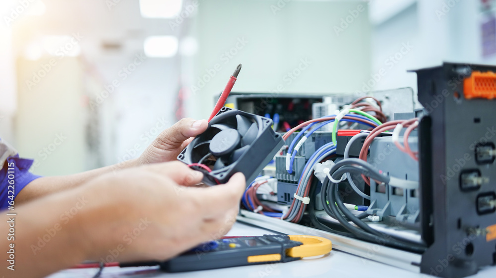 Electrical engineer checking and fixing automatic control switchboard ...
