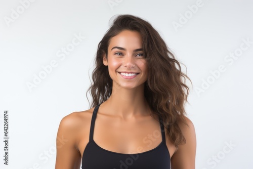 Portrait of a smiling sportswoman in black sportswear isolated on a white background and Looking at the camera.