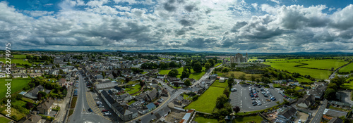 Fototapeta Naklejka Na Ścianę i Meble -  Aerial panorama of Cashel town , Rock of Cashel iconic Irish historic landmark with Romanesque chapel, a Gothic cathedral, an abbey, the Hall of the Vicars Choral and a fifteenth-century Tower House