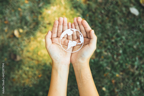 Top view hand holding Earth planet icon symbolize eco-friendly commitment to environmental protection and zero carbon emission. Earth World Day concept to promote eco awareness. Gyre photo