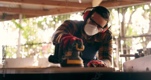 Construction, carpenter and handyman with wood project in workshop at home for renovation and maintenance. Contractor, machine an person with ppe and bokeh in workplace at house for for carpentry photo