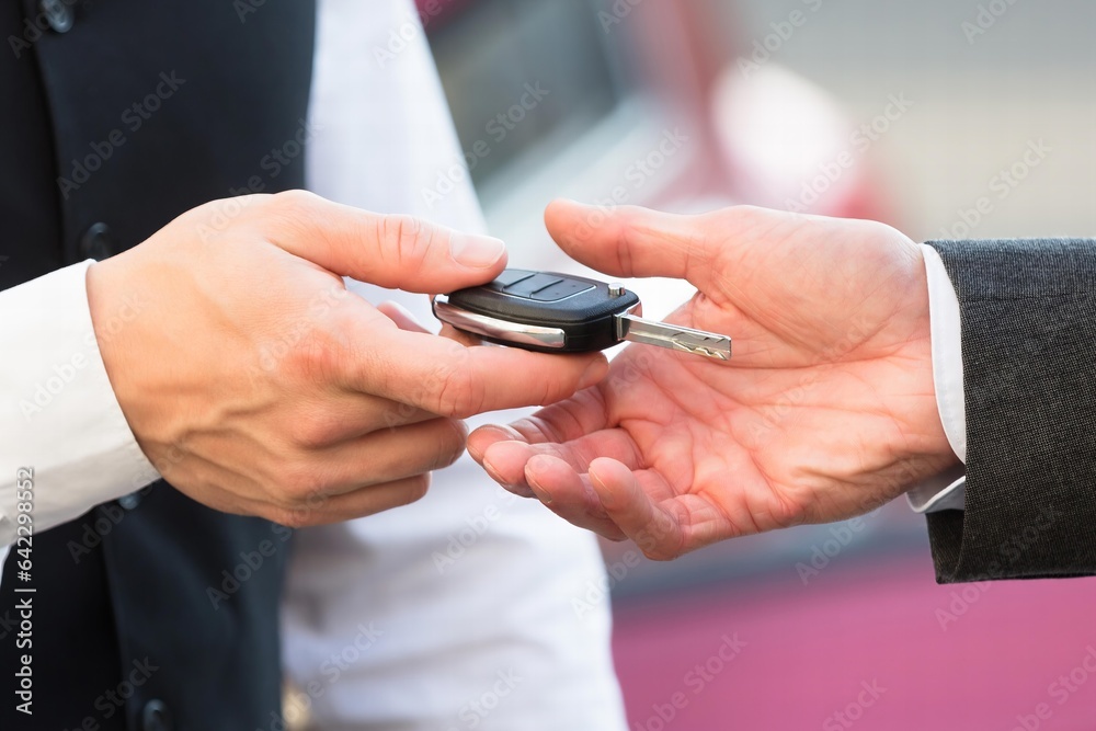 Fototapeta premium Valet Giving Car Key To Businessperson