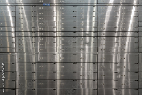 Obraz na płótnie Safe deposit boxes inside bank vault with closed steel doors. Metal deposit lockers, Space for text, Selective focus. w salonie