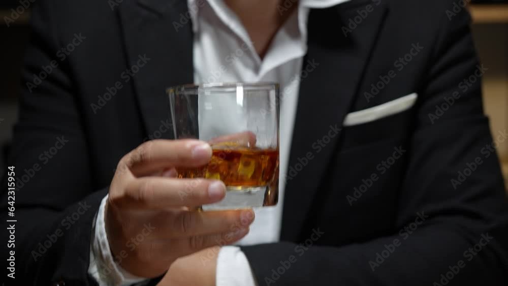 businessman holding whiskey, a restaurant businessman holding whiskey, a restaurant