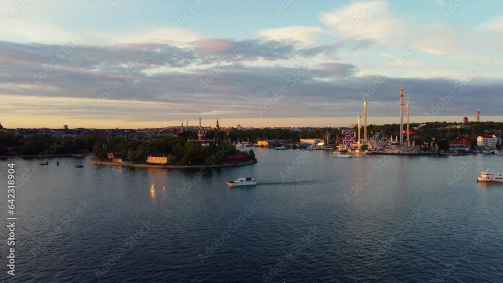 Beautiful view an amusement park in Stockholm at sunset, with boats passing by. Beautiful view an amusement park in Stockholm at sunset, with boats passing by.