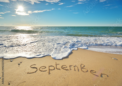 September word on sea sand.
