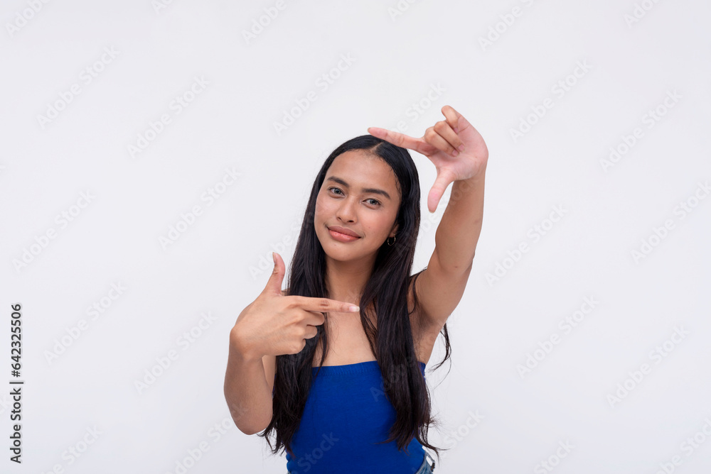 A young Filipino woman gesturing a picture frame with both hands. Isolated on a white background. A young Filipino woman gesturing a picture frame with both hands. Isolated on a white background.