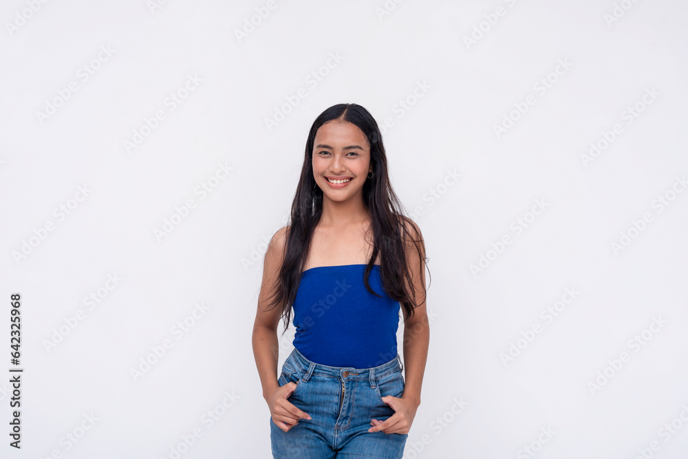 A young Filipino woman in a blue tube top and jeans. Isolated on a white background. A young Filipino woman in a blue tube top and jeans. Isolated on a white background.