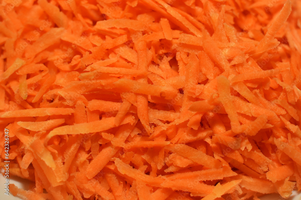 Background of fresh red grated carrots for cooking, close-up Background of fresh red grated carrots for cooking, close-up