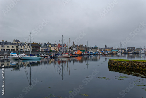 Looking down the waterfront of Stornoway on the Isle of Lewis on an overcast morning, with Yachts and the Lifeboat moored up at Low Tide.