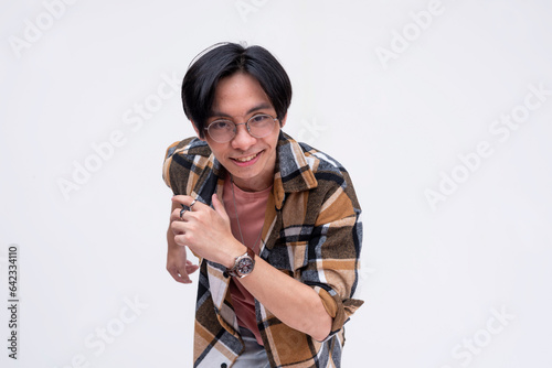 A young chinese man running forward in an exaggerated way. Active dynamic teenager in motion. Isolated on a white backdrop. photo