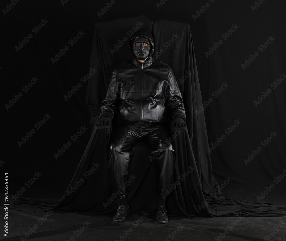 portrait of a man in a strange theatrical mask on a black background