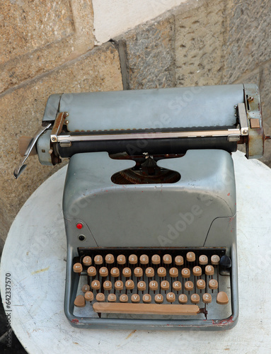 vintage typewriter for sale in flea market above a small table © ChiccoDodiFC