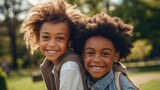 African American boy and girl hug happily amidst the beauty of a park, radiating positivity.