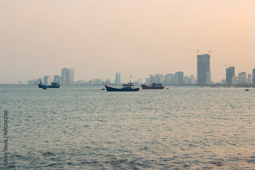 South China Sea coastline with views of Da Nang buildings and fishing boats in the sea in summer suns