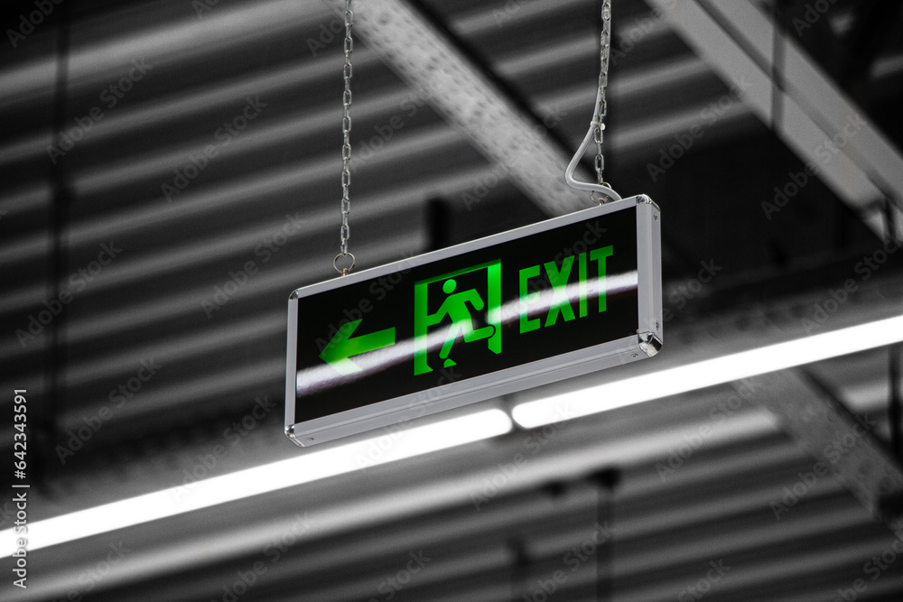 green exit sign hanging from the ceiling green exit sign hanging from the ceiling