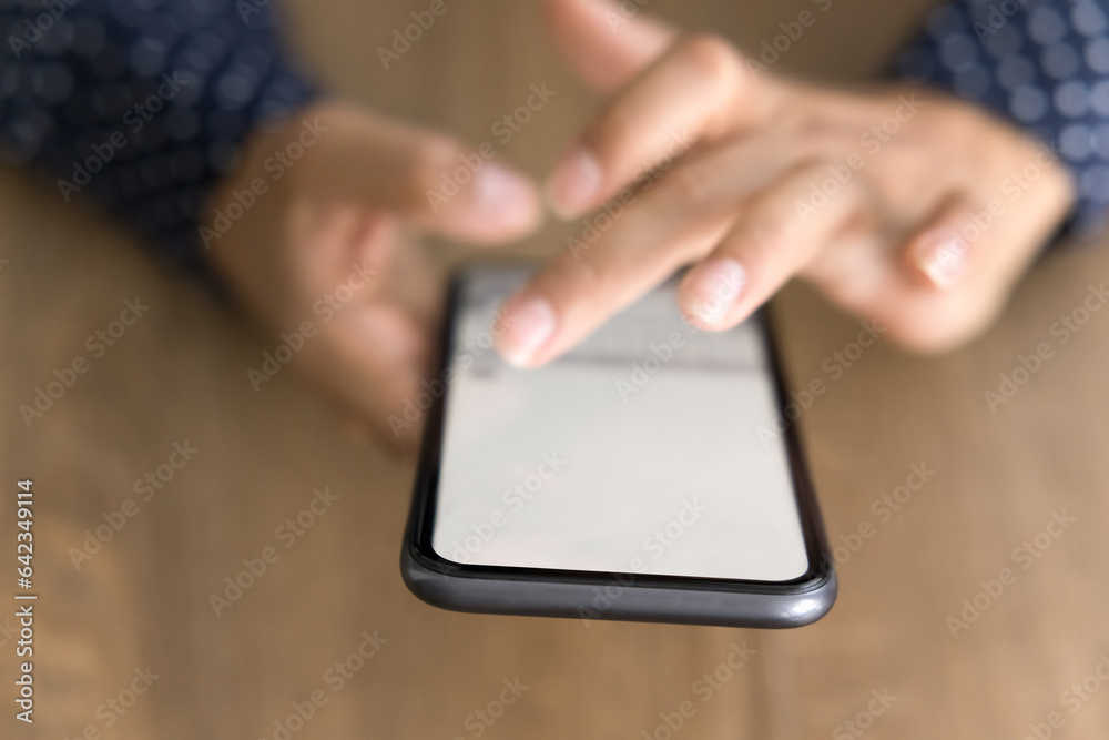 Screen of mobile phone in female hands over table surface. Young business woman touching display of smartphone, using online application, service, digital gadget for Internet communication. Close up Screen of mobile phone in female hands over table surface. Young business woman touching display of smartphone, using online application, service, digital gadget for Internet communication. Close up