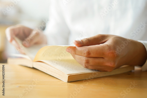 Canvas Print close up young man hand open bible book and reading sentence and worship in the