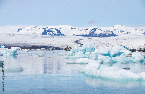 Ice floes in a glacial lake in Iceland with vulcano mountains in the background, the climate crisis in northern Europe, glacial melting, beautiful landsacpe © jochen