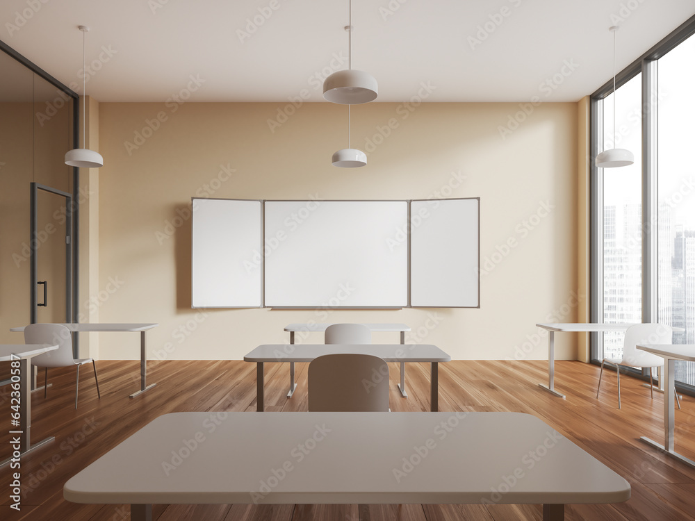 Fototapeta premium Beige stylish classroom interior with table in row and empty mockup chalkboard