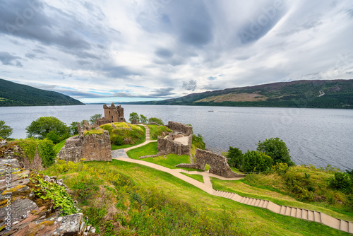 Great panorama of Loch Ness with Urquhart Castle on a hill by the loch, Scotland. photo