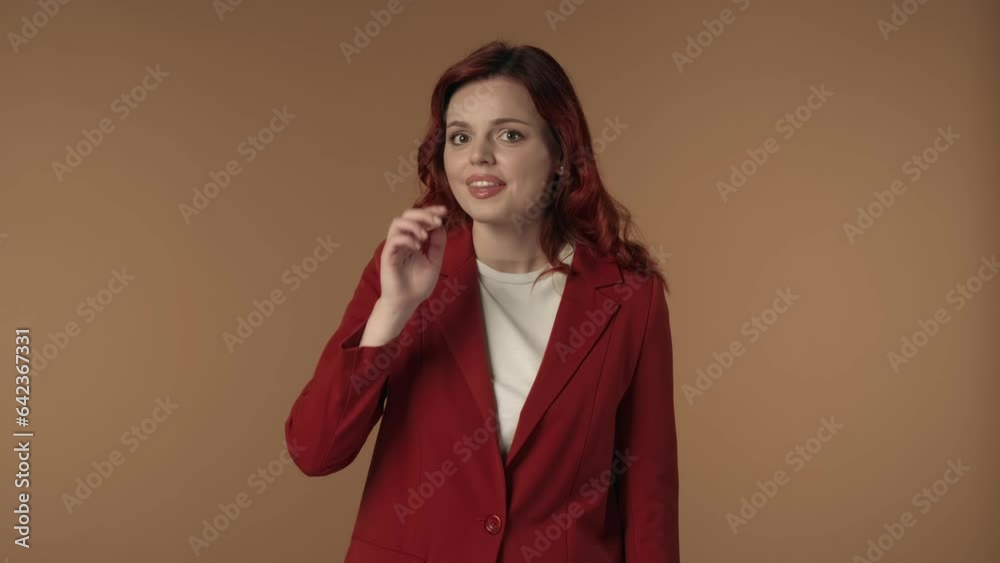Medium isolated video of a joyful young woman looking to the sides, then covering her mouth to share a secret, whispering. Medium isolated video of a joyful young woman looking to the sides, then covering her mouth to share a secret, whispering.