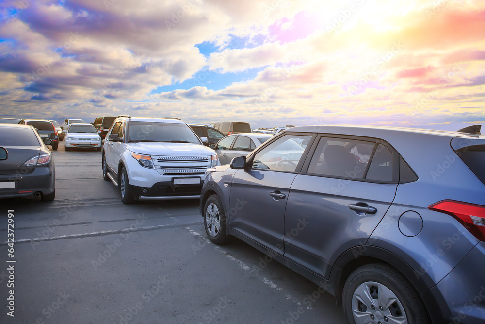 Cars in the parking lot at sunset