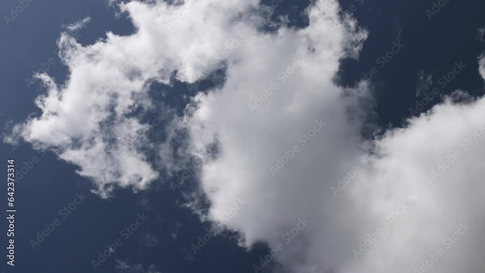blue sky with white clouds and bright sunlight, clouds against a blue spring sky blue sky with white clouds and bright sunlight, clouds against a blue spring sky