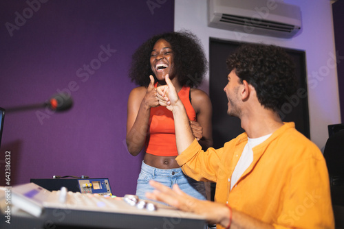Man and black woman approving recorded sound photo