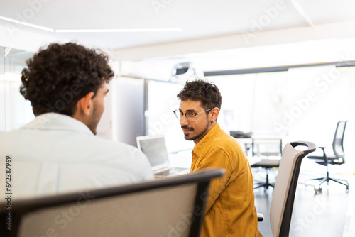 Men colleagues working in modern office together